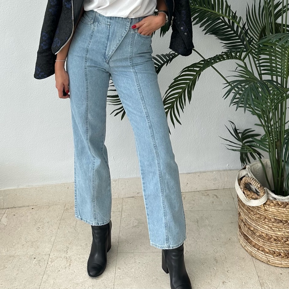 The Cover denim front flap over light wash jeans